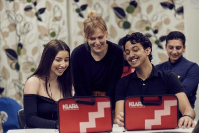Larare hjalper elever med en uppgift